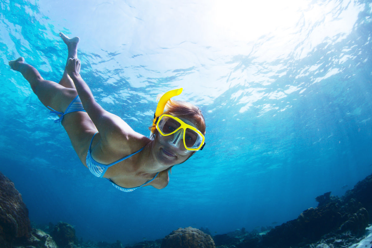 a picture of a girl snorkleing at baby beach aruba