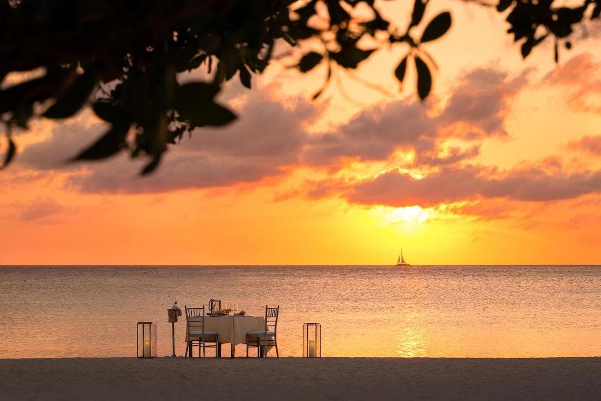 a dining table set up on Palm Beach in Aruba