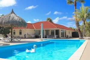 the outdoor pool and sun terrace at Villa Florida in Noord, Aruba, Dutch Caribbean.