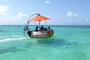 taking a ride on an aqua donut at Palm Beach, Aruba.