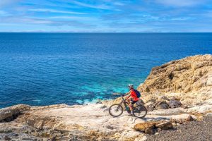 a mountain biker staring over the ocean in Aruba