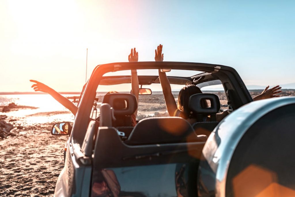 Two girls having fun driving around Aruba in a Jeep.