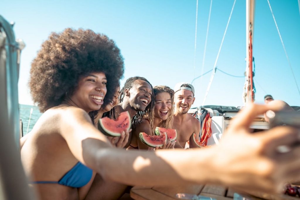 People having a good time taking selfies on a catamaran cruise in Aruba