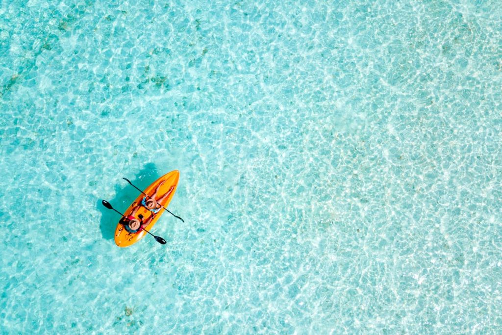 A couple kayaking in the tropical waters of Aruba, Dutch Caribbean.