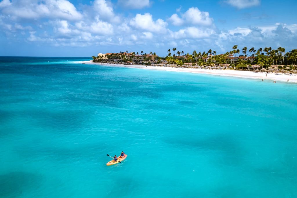 A kayak floating on the water in front of Druif Beach, Aruba.