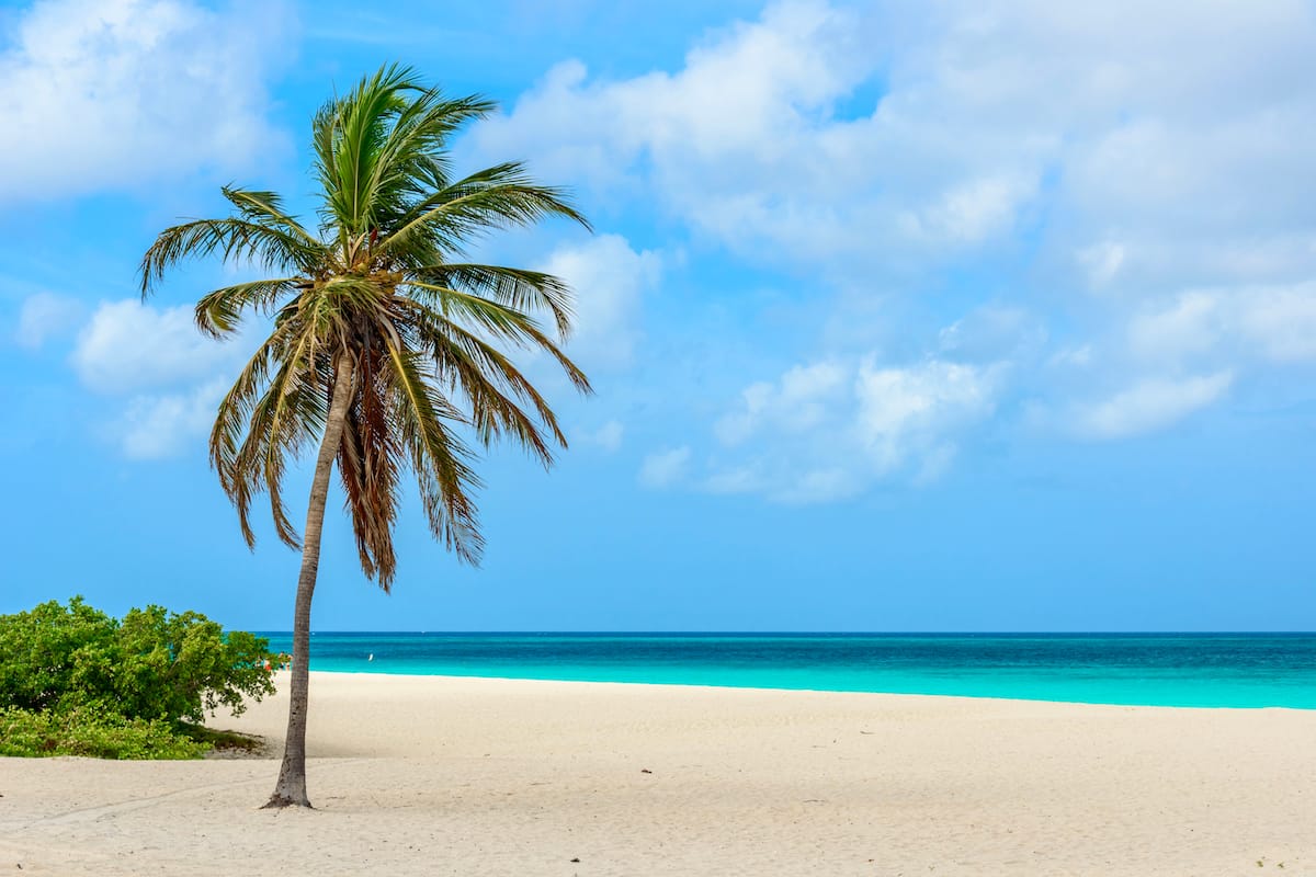 This picture of Surfside Beach shows a stunning view of the beach, with powdery sand and clear, blue water.