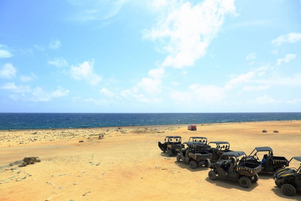 a group of UTV vehicles exploring the coast of Aruba Noord