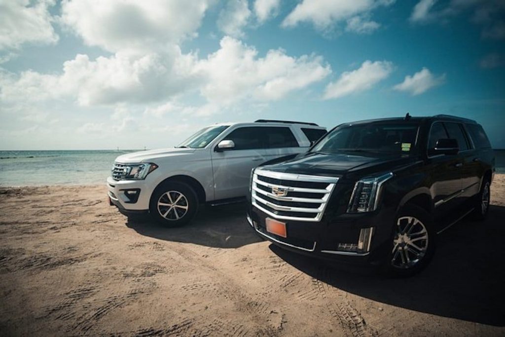 SUV vehicles waiting on the beach to pick up passengers from the airport