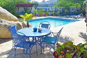 a villa with an outdoor pool and terrace at Malmok Beach, Aruba.