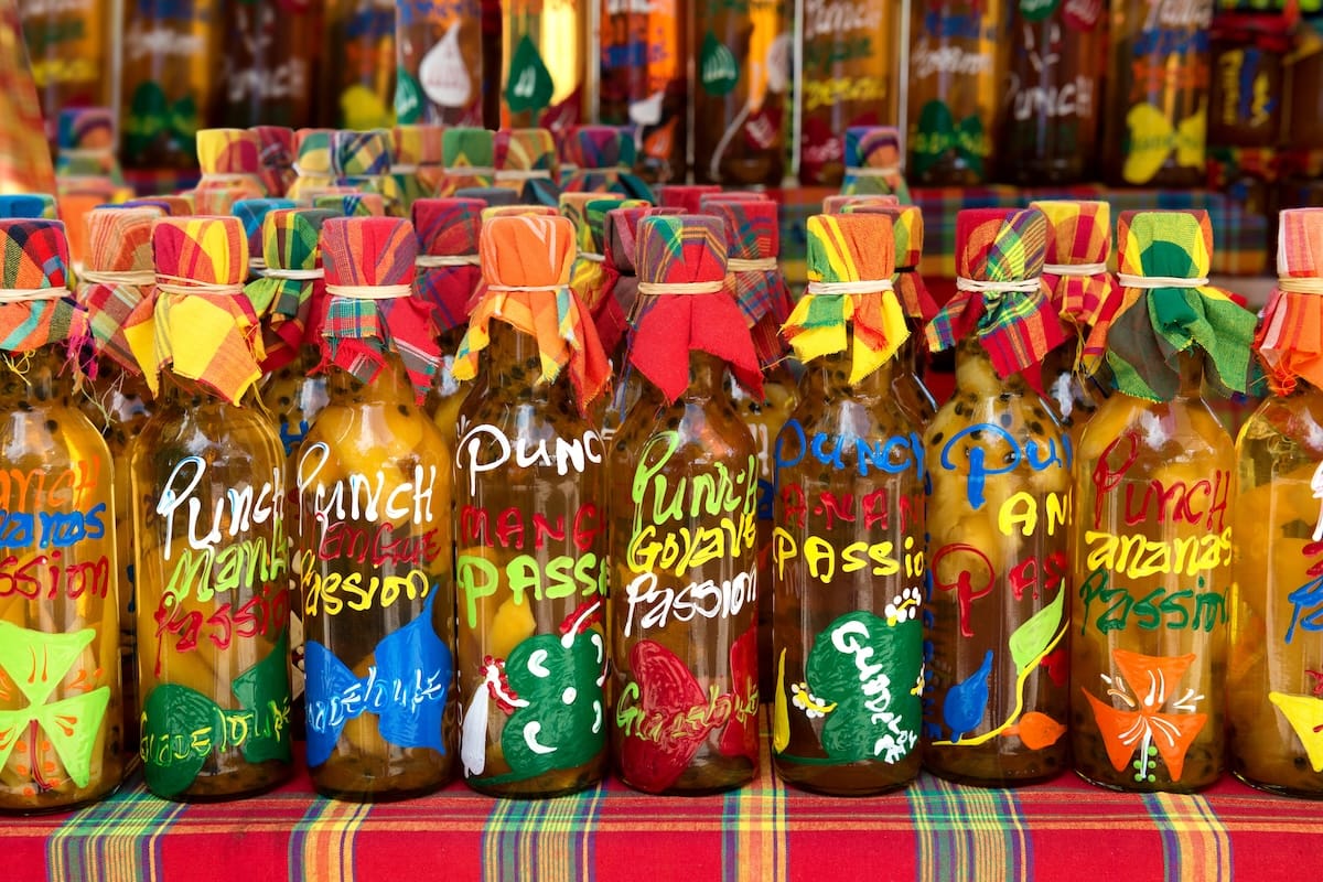 A selection of bottled fresh Caribbean fruit juices laid out on a table.